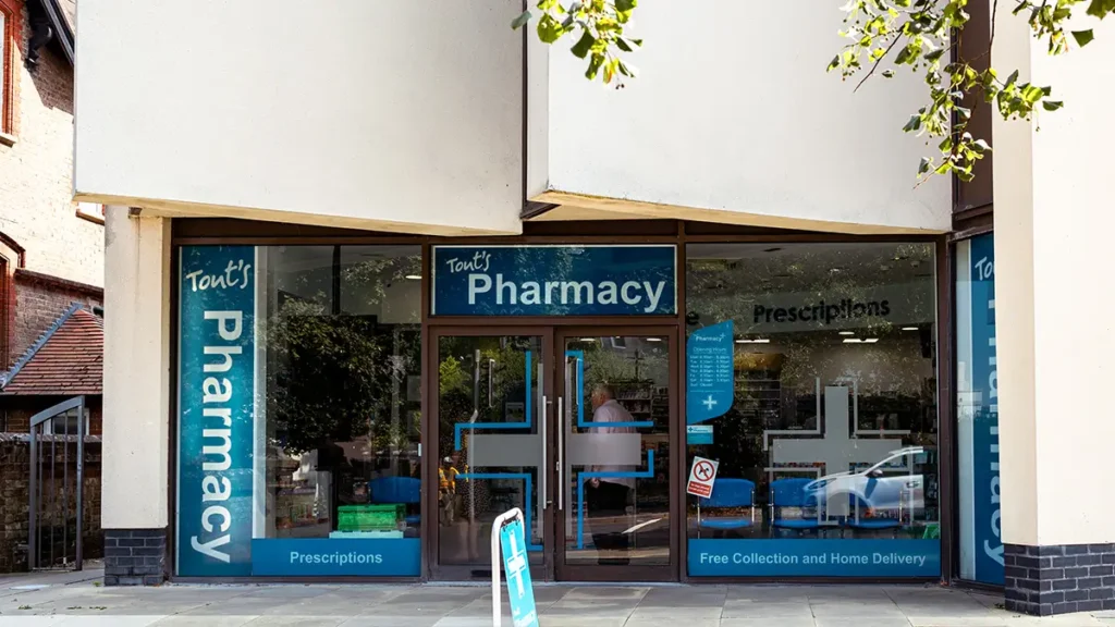 Tout’s Pharmacy storefront at Brewery Square Dorchester with prescription signage and glass entrance